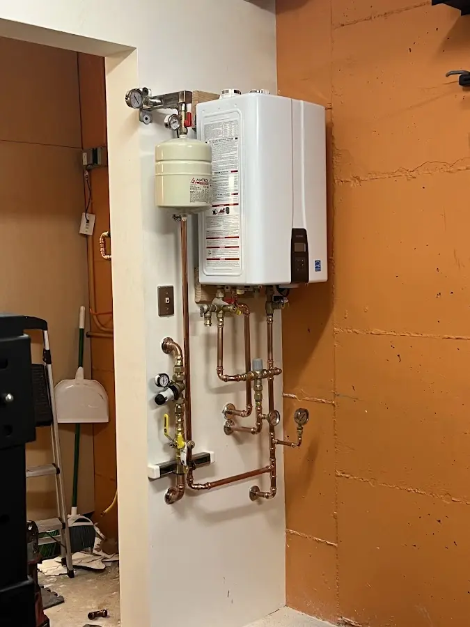 Plumbing technician inspecting water heater connections in Banning